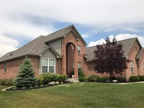 Shingle roof and front entry on a brick home