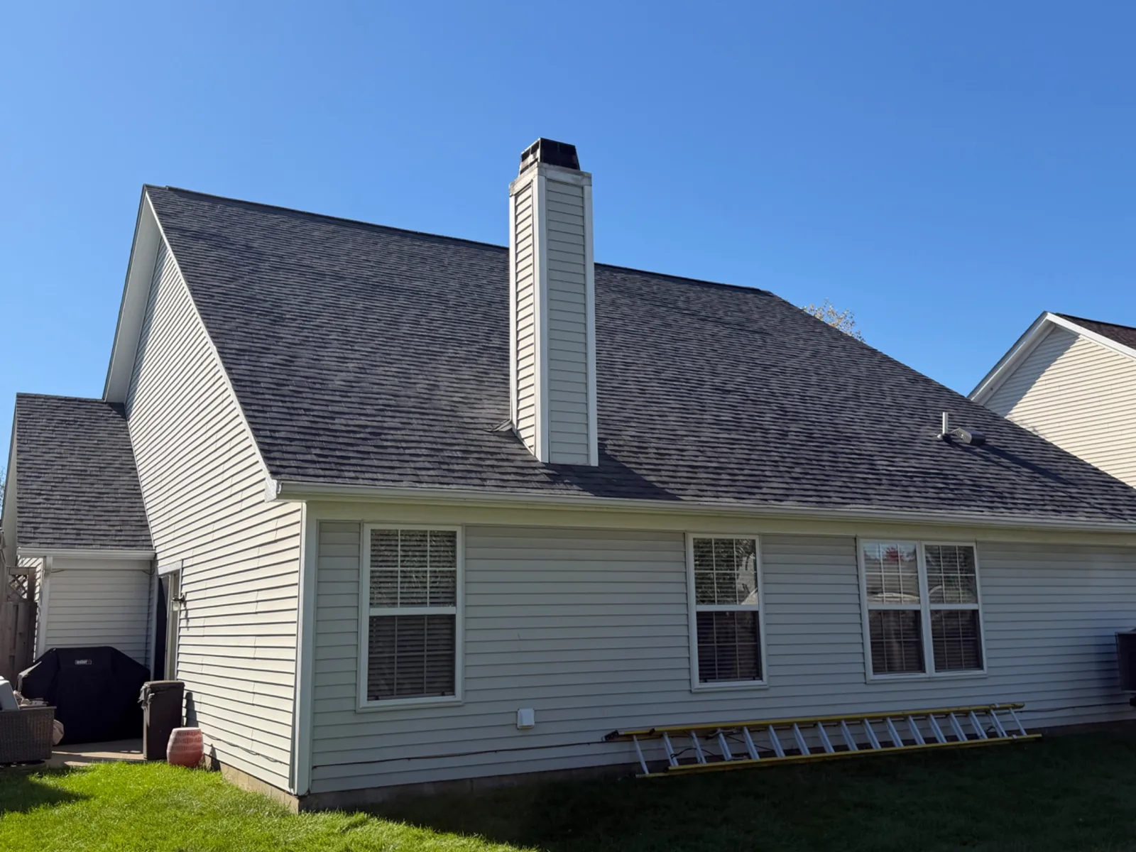 Rear roof slope and chimney after an Owens Corning Duration Estate Gray roof replacement in Fishers, Indiana