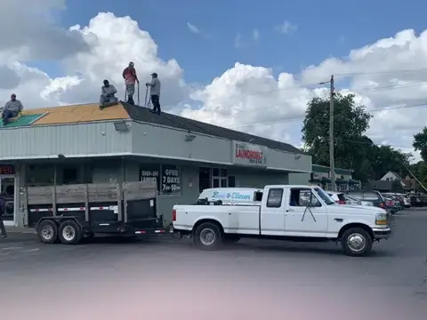 Roofing crew replacing a commercial building roof