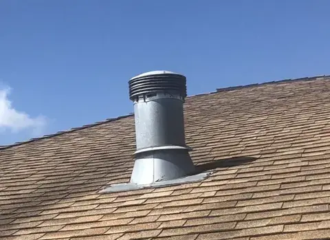 Roof pipe flashing and surrounding shingles