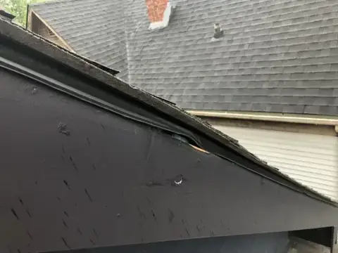 Roof-to-wall junction before roof repair