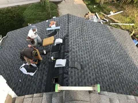 Roof Masters & Exteriors crew installing roof shingles in Indianapolis, IN
