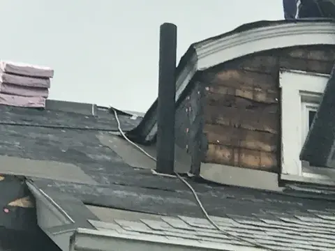Roof detail beside a dormer and vent pipe