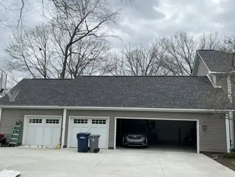 Completed shingle roof above a three-car garage