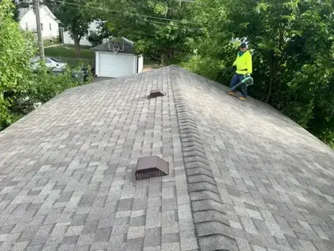 Completed shingle roof ridge with rooftop vents