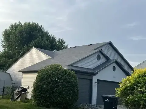 Completed shingle roof above a garage and front gable
