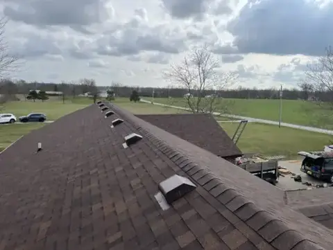 Completed brown shingle roof with rooftop vents
