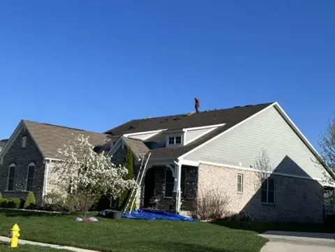Completed shingles above a stone home entry