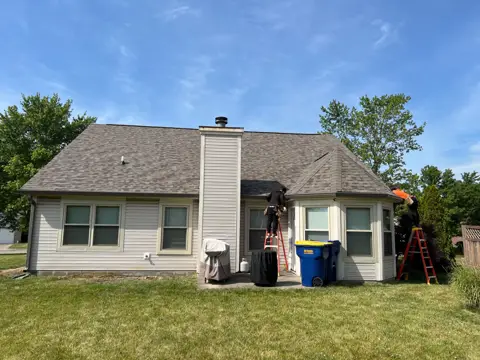 Owens Corning Duration Driftwood roof installation in Lawrence, Indiana — rear roof and chimney view