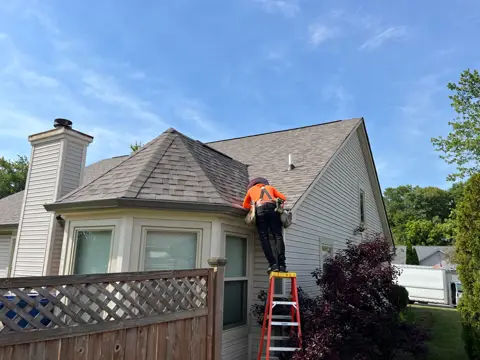 Owens Corning Duration Driftwood roof installation in Lawrence, Indiana — bay-window roof and adjoining slopes